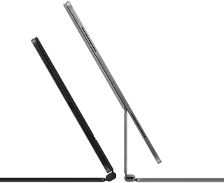 Two iPad Pro devices attached to Magic Keyboard, side exterior, thin profile, space black colour with speakers and USB-C port, tilted half open, silver colour, open, tilted back showing the keyboard’s floating cantilever design, speakers and microphone